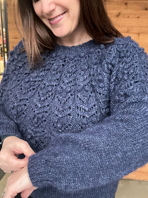 closeup image of the textured yoke of a pullover handknit sweater