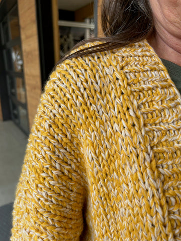 closeup image of the fabric of a handknit sweater