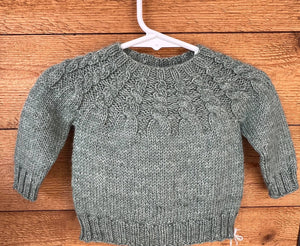 cabled yoke of handknit baby sweater