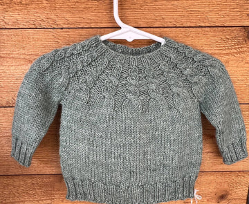 cabled yoke of handknit baby sweater
