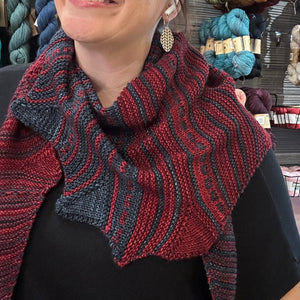 2-color handknit shawl modeled by a woman