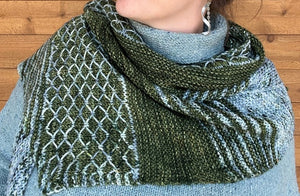 closeup image of striped and textured handknit shawl modeled by a woman