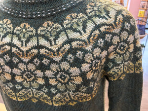closeup image of the floral yoke of a pullover handknit sweater 