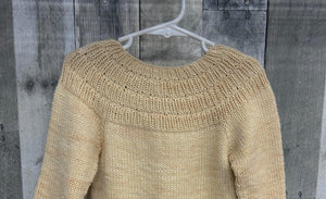closeup image of the texture of a pullover handknit baby sweater