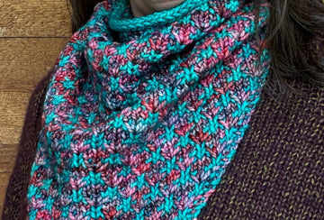 closeup image of the fabric of a 2-color handknit cowl
