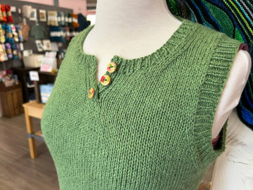 closeup image of the fabric and buttons on a handknit top