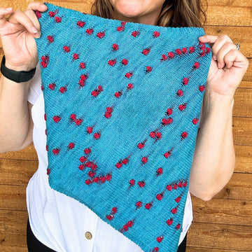 closeup image of planned-pooling stitch pattern on  a handknit cowl