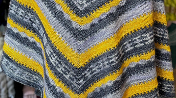 closeup image of 3-color stripe patterned handknit shawl