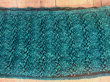 closeup image of a lacework fabric of a handknit cowl