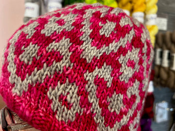 closeup image of the two color pattern of a handknit hat
