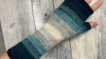 blue tonal striped handknit fingerless mitts at a local yarn shop