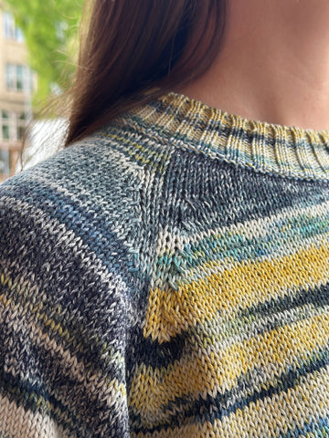 closeup image of the fabric of a handknit pullover sweater