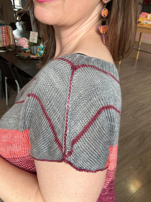closeup image of the fabric and shoulder detail of a handknit top