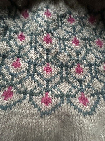 closeup image of the colorwork yoke of a pullover handknit sweater 