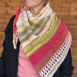 closeup image ofstriped cozy cotton triangle shaped  handknit shawl