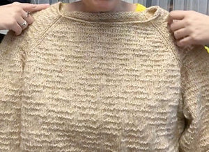 closeup image of the textured fabric of a handknit sweater