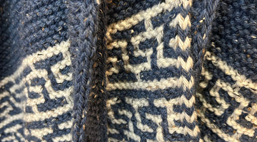 closeup image of the lace and textured yoke of pullover handknit sweater 