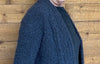 closeup image of the fabric of a handknit cardigan