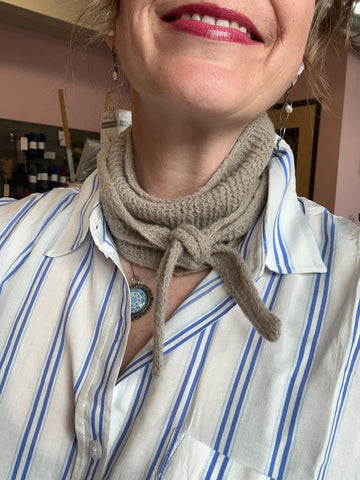 closeup image of a handknit scarflette modeled by a woman