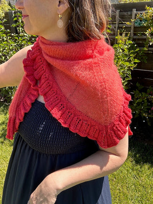 closeup image of ruffled lace lightweight triangle shaped  handknit shawl