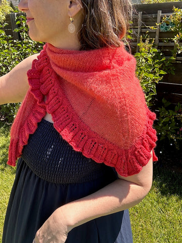 closeup image of ruffled lace lightweight triangle shaped  handknit shawl