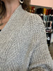 closeup image of the textured fabric of a cardigan handknit sweater