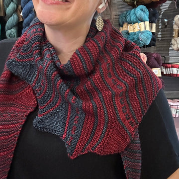 2-color handknit shawl modeled by a woman