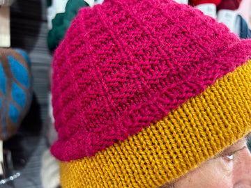 closeup image of a textured, 2-color, handknit hat